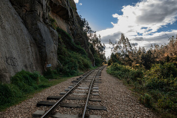 Fototapeta na wymiar Old Railway with rocky mountains and stone walls on a sunny day in Suesca, Cundinamarca - Colombia