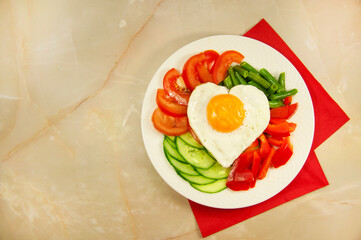 healthy breakfast with egg, bread, tomatoes slice, cucumber slice, and green beans for Valentine's day morning