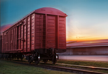 Obraz premium Freight train traveling by rail. View of the rear carriage of the train.