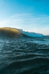 Breaking Waves and spray, white water and light reflected on the surface of the water