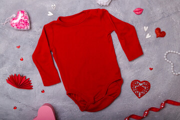 Red baby clothing mock up flat lay with decor for the Valentine's Day for your logos and texts