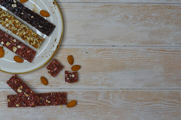 set of oatmeal, buckwheat and rice cereal bars on wooden table, protein sports food for weight control