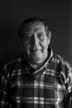 Senior man against black background