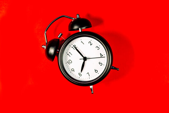 Alarm clock against red background