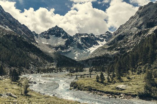 Scenic view of river flowing through Valmalenco valley in spring