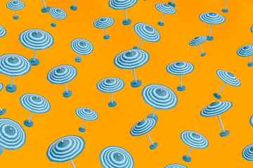 Blue beach umbrellas on orange background