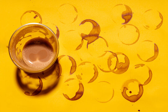 Coffee cup on coffee stained yellow table