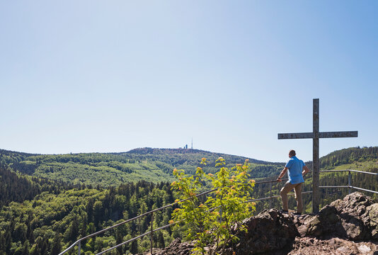 Clear sky over senior hiker admiring Thuringian Forest from observation point