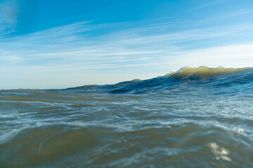 Breaking Waves and spray, white water and light reflected on the surface of the water