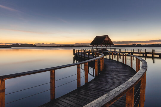 Fototapeta Germany, Schleswig-Holstein, Hemmelsdorf, Empty pier on shore of Hemmelsdorfer See lake at dawn