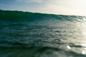 Breaking Waves and spray, white water and light reflected on the surface of the water