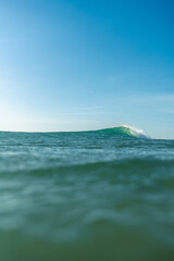 Breaking Waves and spray, white water and light reflected on the surface of the water