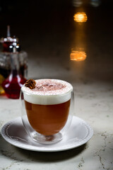Glass of irish coffee on a table. classic irish coffee saved on a dark bar with a float of heavy cream