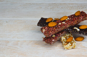set of oatmeal, buckwheat and rice cereal bars on wooden table, protein sports food for weight control