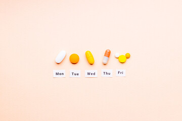 medicine drugs daily and weekly schedule concept. above view. drug medication reminder conceptual. pink background. outer space