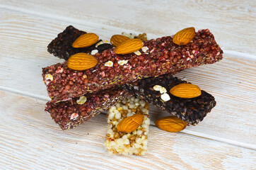 set of oatmeal, buckwheat and rice cereal bars on wooden table, protein sports food for weight control