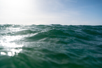 Breaking Waves and spray, white water and light reflected on the surface of the water