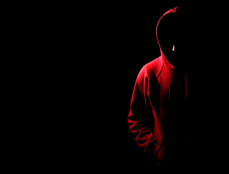 Young man wearing red hooded top