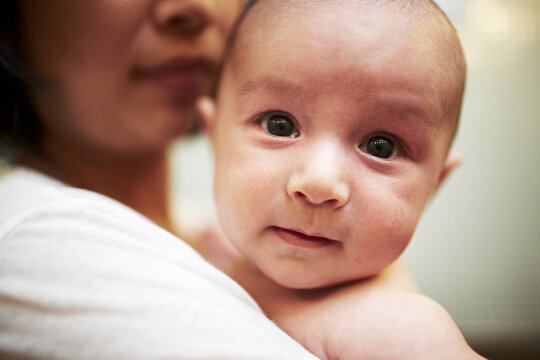 Mother holding baby son, close up
