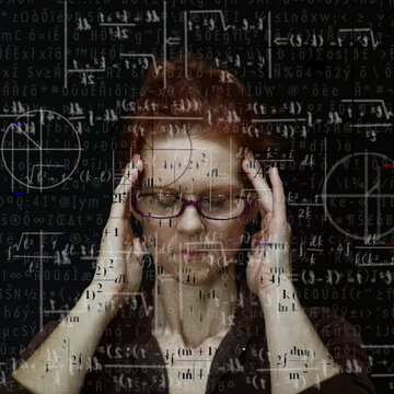 Woman concentrating on solving mathematical equation
