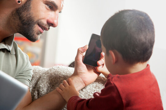 Father showing son smart phone