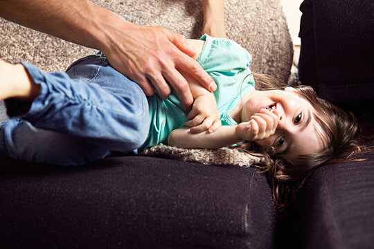 Father tickling daughter