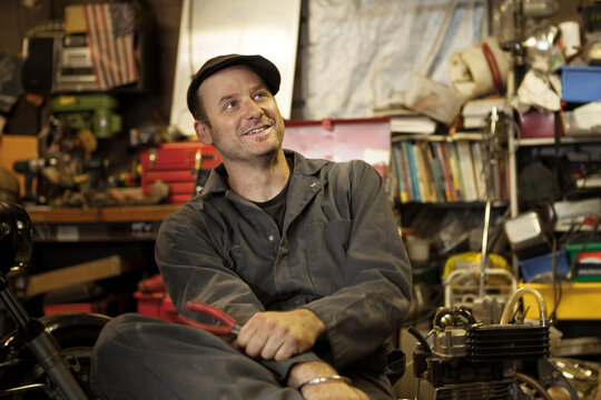 Mechanic in his garage converting gas powered motorcycles to Bio-Diesel