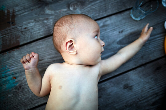 Baby boy lying on wooden table