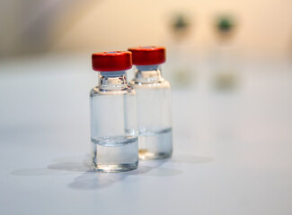 closeup of two vaccine bottles, selective focus