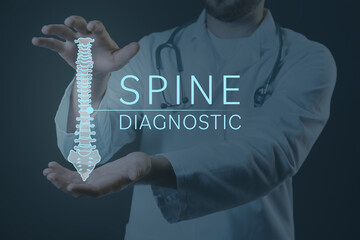 Male doctor with holographic projection of human spine on dark background. Innovative technologies...