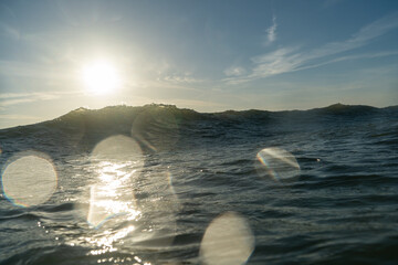 Breaking Waves and spray, white water and light reflected on the surface of the water