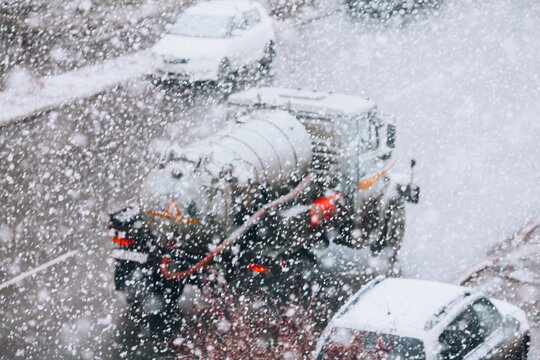 Snowfall On The Road, Blurred Background On The Theme Of Snowfall, Bad Road Conditions And Weather Forecast