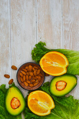fresh vegetables and fruits, avocado, orange, lettuce, almonds, healthy and vegan food, diet concept, detox, body weight control, products for immunity