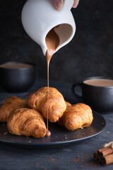 Fresh and delicious croissants with chocolate and a cup of coffee. Breakfast, banner, background.