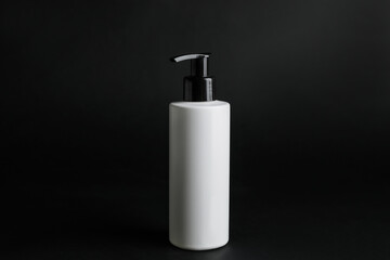 Bottle of cosmetic product on black background