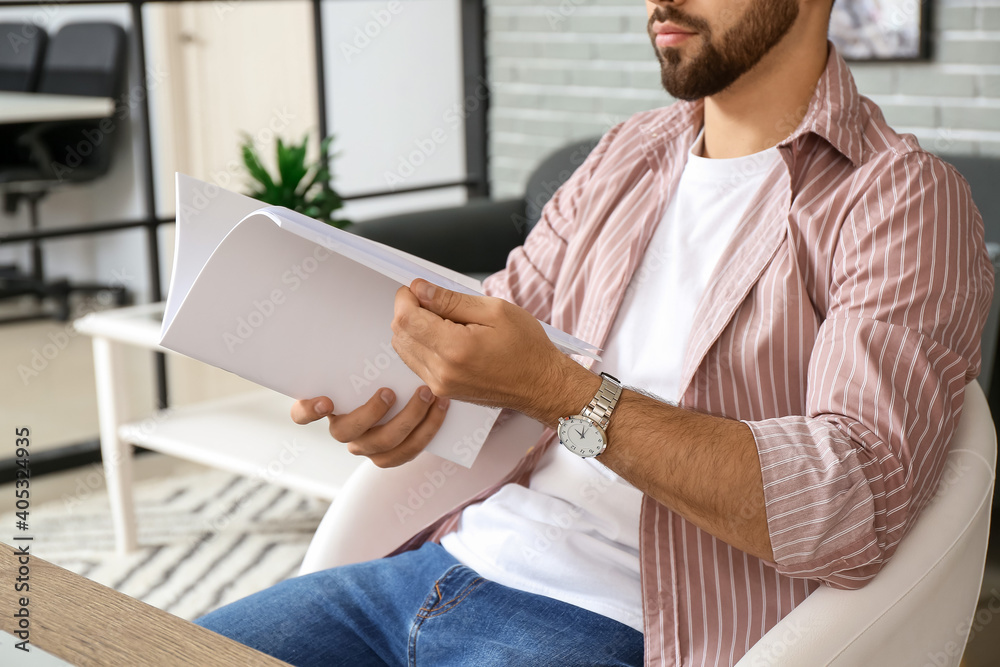 Canvas Prints young man reading magazine at home