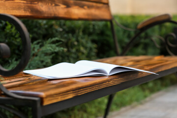 Blank magazine on bench in park