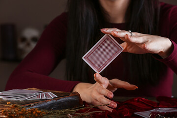 Fortune teller with cards reading future at table