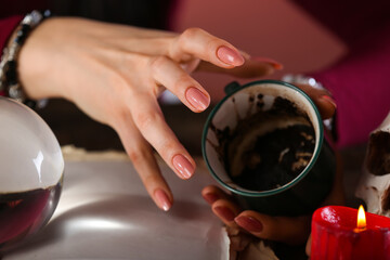 Fortune teller reading future at table