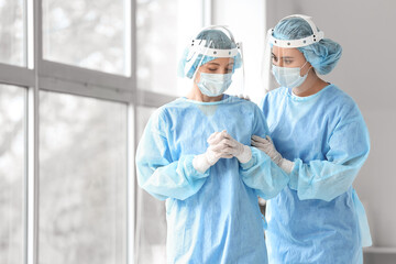 Fototapeta na wymiar Female surgeon calming her colleague after operation in clinic