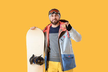 Male snowboarder with credit card on color background