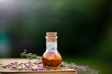 Obraz na płótnie Canvas Bottle of essential oil with fresh herbal sage,