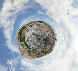 rocky landscape at the sea with mountain on croatian island krk as little planet panorama