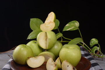 green apple pile on black background