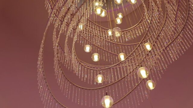 CU LA Close up of chandelier against pink celling
