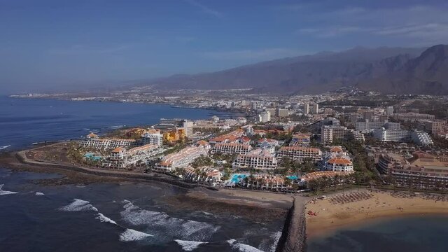 Aerial panorama of Los Cristianos resorts and Playa del Camison beach, Tenerife, Canary islands, Spain. 2.5x speeded up from 24 fps.