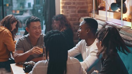 Lovely company of carefree multi-ethnic nice people sharing common table having warm conversation on coffee break. Meeting. Friendship. - Powered by Adobe