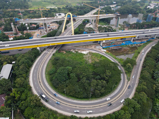 Aerial drone view of highway multilevel junction road with moving cars and noise cloud. BEKASI, INDONESIA : JANUARY 14 2021
