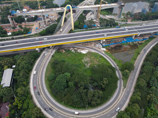 Aerial drone view of highway multilevel junction road with moving cars and noise cloud. BEKASI, INDONESIA : JANUARY 14 2021