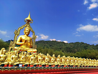 Golden Buddha statue with among 1,250 Buddha statue at Makha Bucha Buddhist memorial park located at Nakhon nayok province, Thailand.